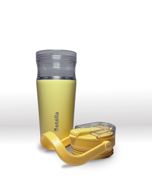 Light yellow nesting tumbler with detachable yellow lid on a white background