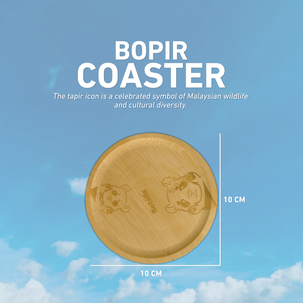 A round bamboo coaster with engraved tapir illustrations and the text 'BOPIR COASTER' on a blue sky background with clouds. White text and measurement lines indicate the coaster is 10 cm by 10 cm.